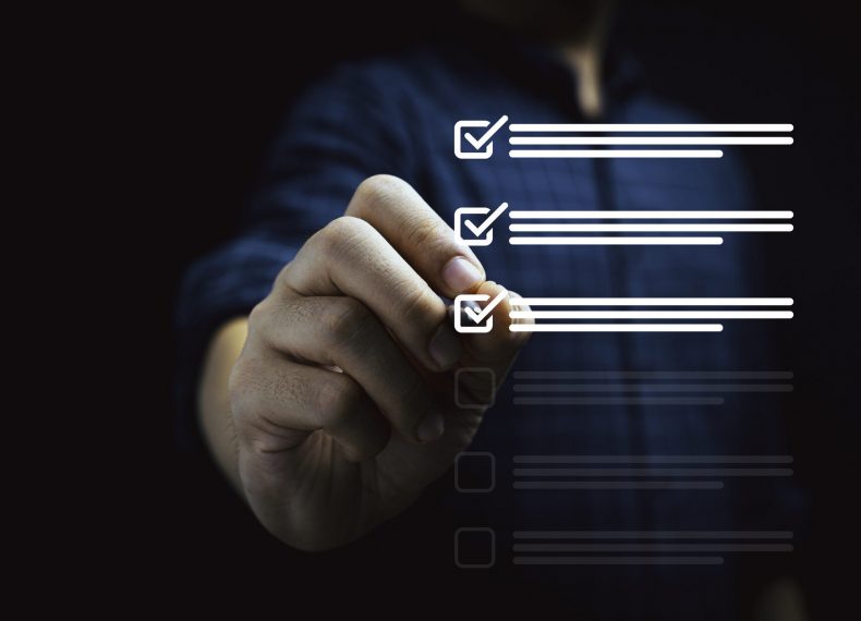 Businessman using pen to tick mark for check review and approve virtual document , Quality assurance and ISO concept.